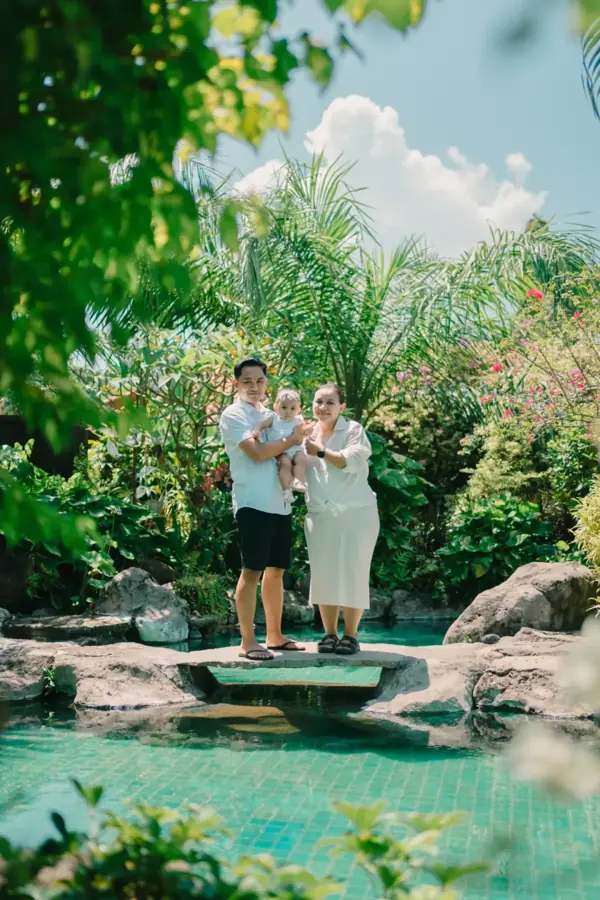 Family photo session at a villa pool in Bali
